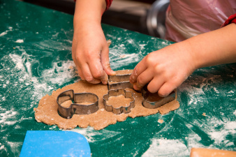 Children stamp out the biscuit shapes
