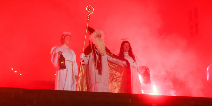 Nikolaus mit Engeln Zwei Frauen in Engelskostüm begleiten den Nikolaus mit Bischofsstab die Domstufen herab