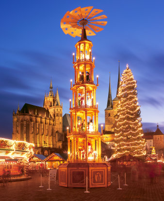 Illuminated, multi-storey pyramid with almost life-sized wooden figures dispenses christmassy flair. 