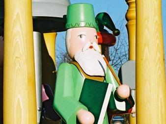 shaped, painted wooden figure with pierced book, sceptre and hat