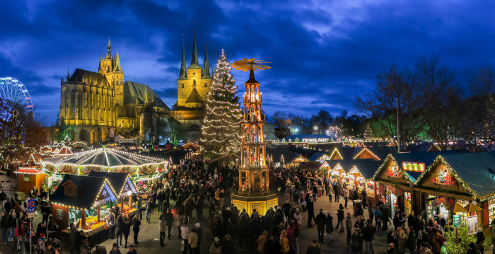 Christmassy illuminated market in the evening with pyramid, Christmas tree, St. Mary's Cathedral and Church of St. Severus